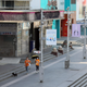 Two people walk by closed stores during lockdown in Shenzhen in south China’s Guangdong province on March 14, 2022.
